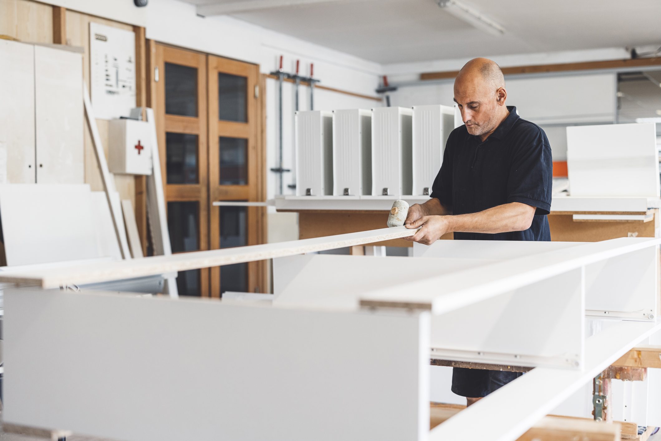 Man assembling furniture in a workshop.